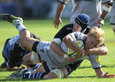 Leicester's Billy Twelvetrees is wrapped up by Bath's Ben Skirving