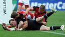 New Zealand's Jimmy Cowan slides across with ball in hand for a try of his own