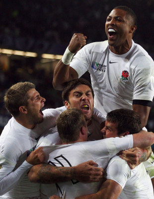 England's Chris Ashton is engulfed after scoring a try
