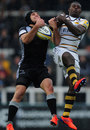 Newcastle's Jamie Helleur takes the ball under pressure from Christian Wade