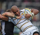 Wasps' Tom Varndell is wrapped up by the Newcastle defence
