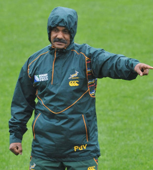 South Africa coach Peter de Villiers shelters from the rain