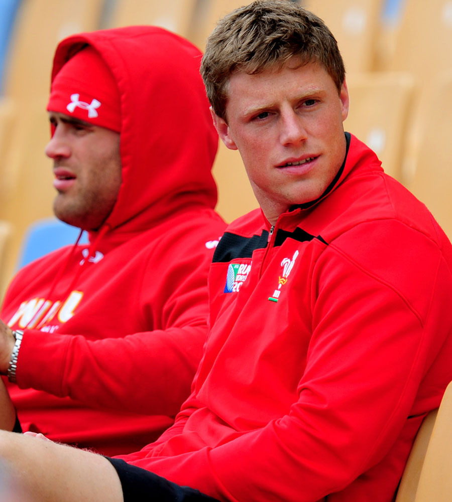 Injured Wales flyhalf Rhys Priestland looks on from the stands during training