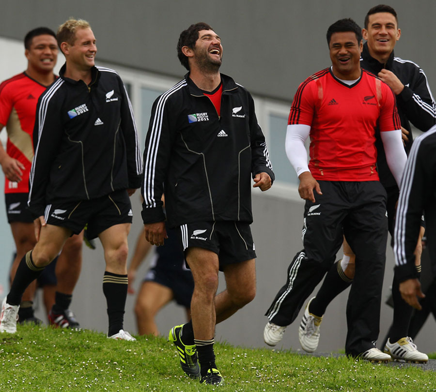 New Zealand fly-half Stephen Donald has a laugh with team-mates as they arrive for training