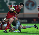 Scarlets centre Rhodri Gomer-Davies breaks a tackle