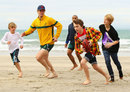 Wallabies Berrick Barnes and Will Genia enjoy some beach rugby with some locals