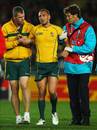 Australia's Quade Cooper is helped from the field