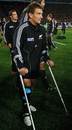 New Zealand's Aaron Cruden walks on crutches after the World Cup final