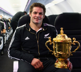 Richie McCaw relaxes with the Rugby World Cup on a flight to Christchurch, Cristchurch Airport, New Zealand, October 25, 2011
