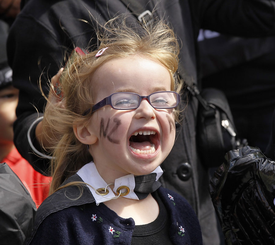 A young New Zealand fan cheers on the World Cup parade