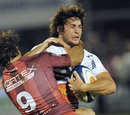 Agen's Maxime Machenaud  is tackled by Montpellier's Thomas Julien
