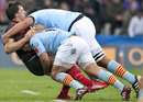 Toulouse's Yannick Jauzion is smashed by two Perpignan defenders