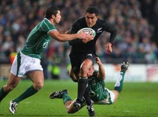 Mils Muliaina of New Zealand runs through the Irish defence during the Guinness Series match between Ireland and the New Zealand All Blacks at Croke Park in Dublin, Ireland on November 15, 2008.