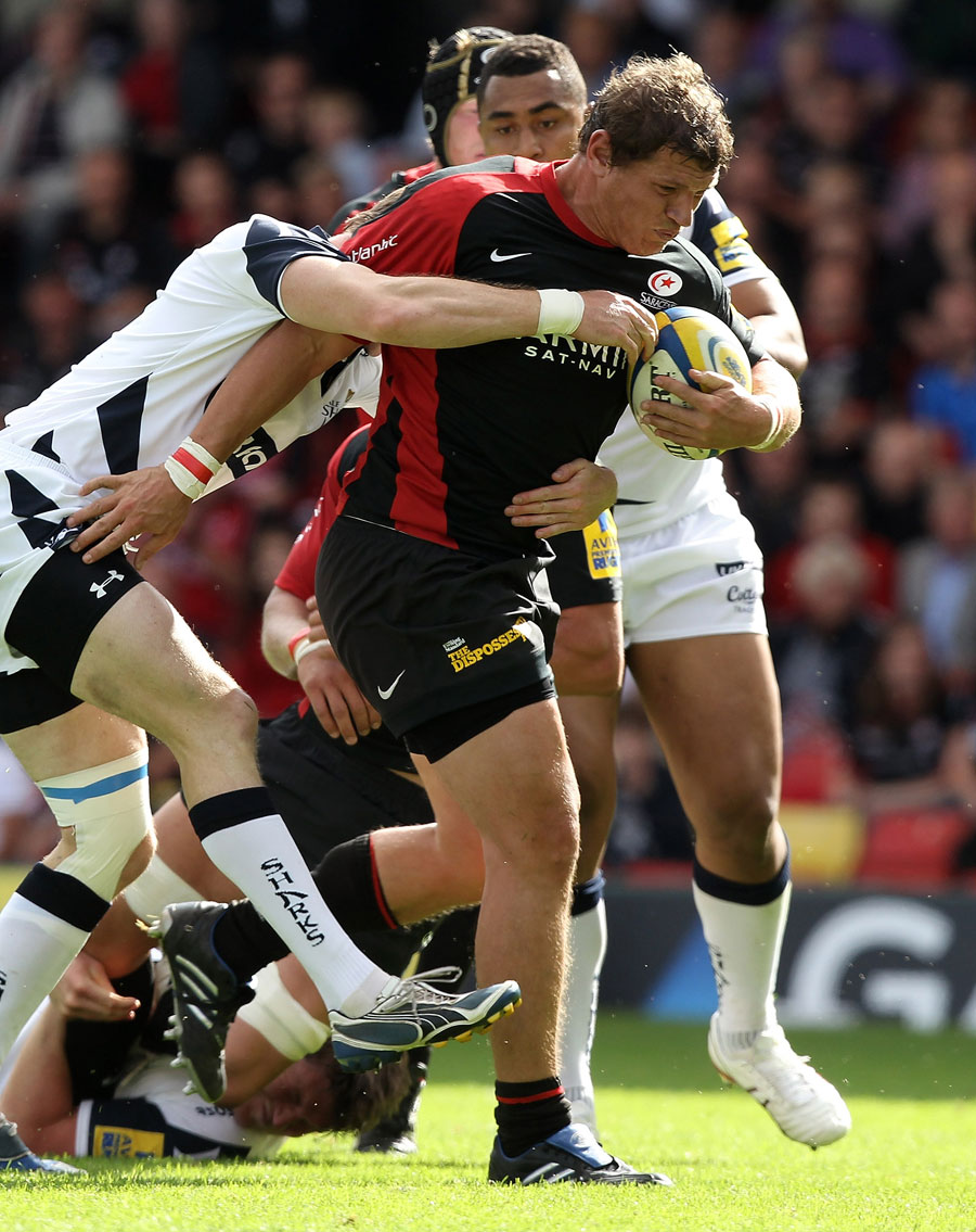 Saracens' Deon Carstens stretches the Sale defence