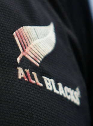 A blood-stained New Zealand rugby logo