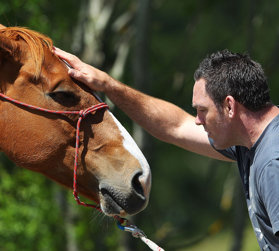 Hurricanes coach Mark Hammett works with his horse 