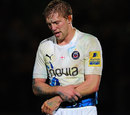 Lewis Moody clutches his injured shoulder