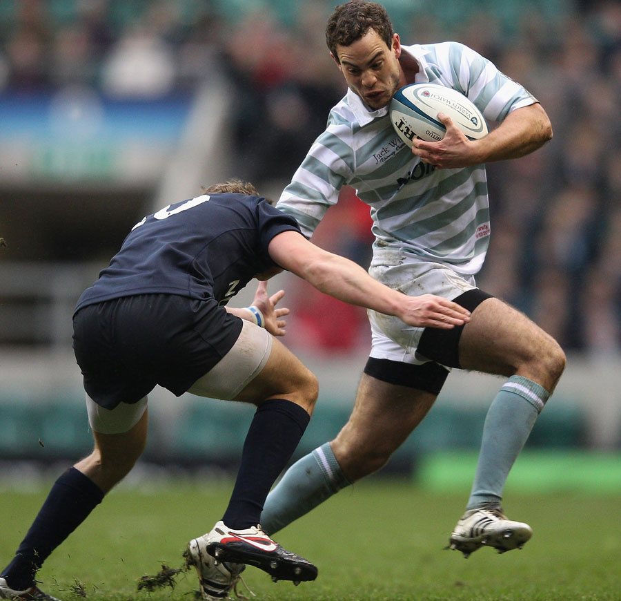 Cambridge's Robert Stevens is tackled by Oxford's Tom Mitchell