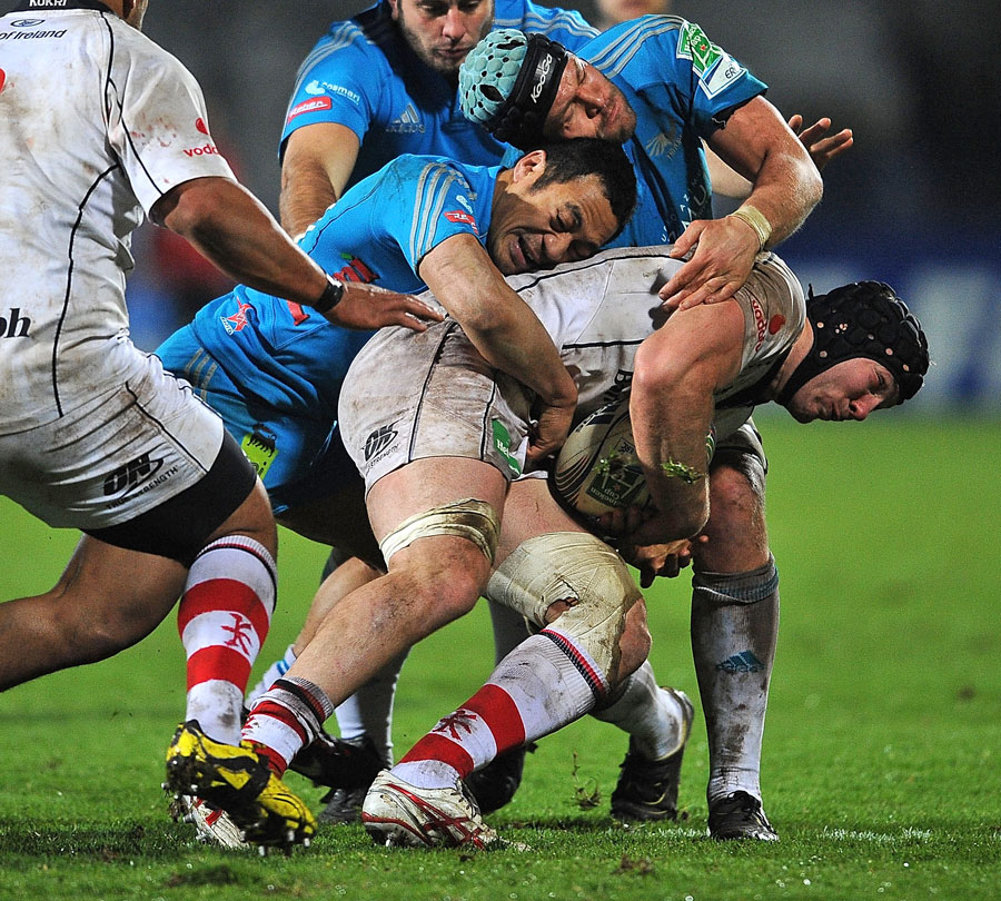 Ulster's Stephen Ferris is wrapped up by the Aironi defence