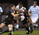 Racing Metro's Sireli Bobo is wrapped up by the Exiles defence