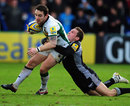 Northampton Saints fly-half Ryan Lamb is tackled by Newcastle's Jimmy Gopperth