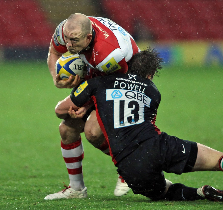 Saracens' Adam Powell tackles Gloucester's Milke Tindall