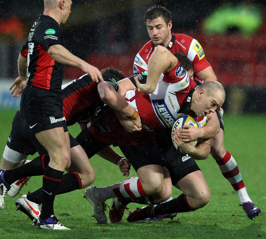 Gloucester's Mike Tindall is shackled by the Saracens defence