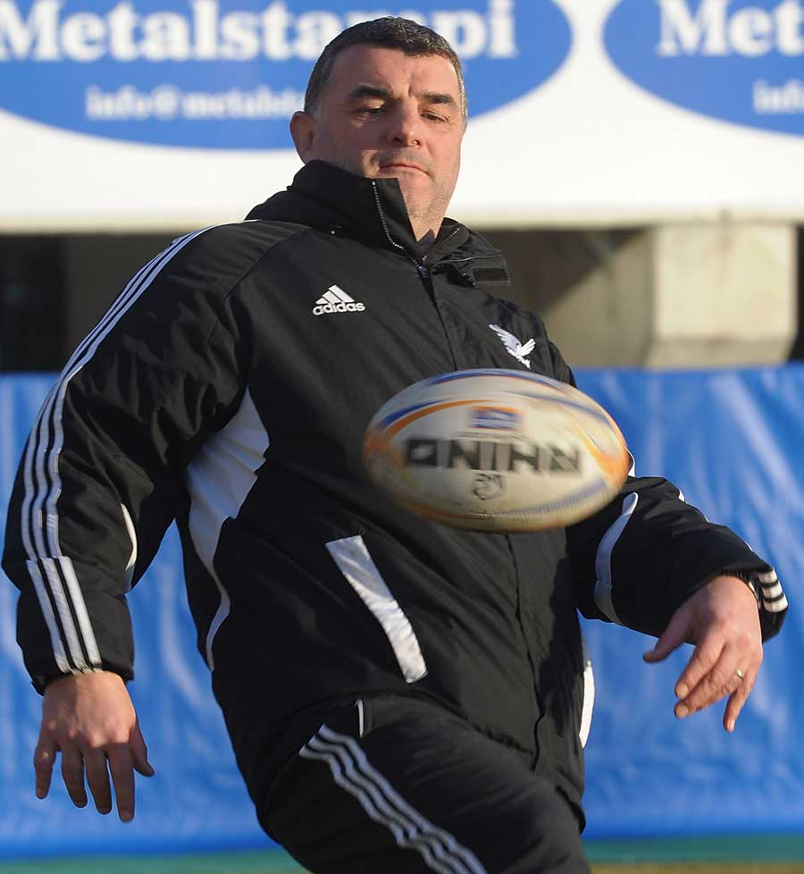 Aironi coach Rowland Phillips attempts to control the ball during training