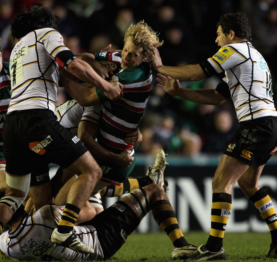 Leicester's Billy Twelvetrees is wrapped up by the Wasps defence