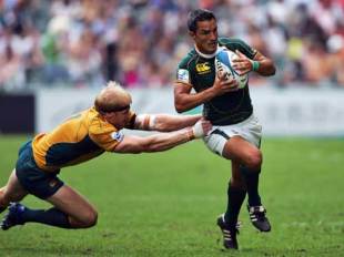 Shawn MacKay of Australia (L) tackles Neil Powell of South Africa during the Cup quarter final match in the Hong Kong Rugby Sevens 2008 in Hong Kong, China on March 30, 2008.