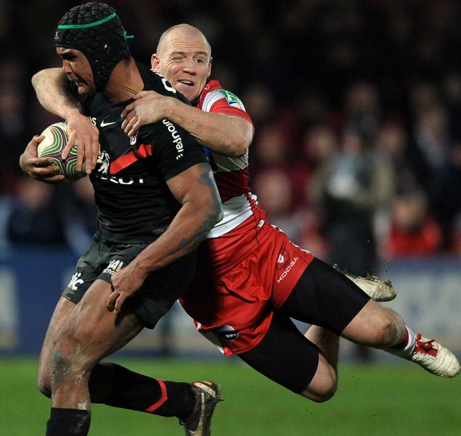 Gloucester's Mike Tindall clings on to Thierry Dusautoir