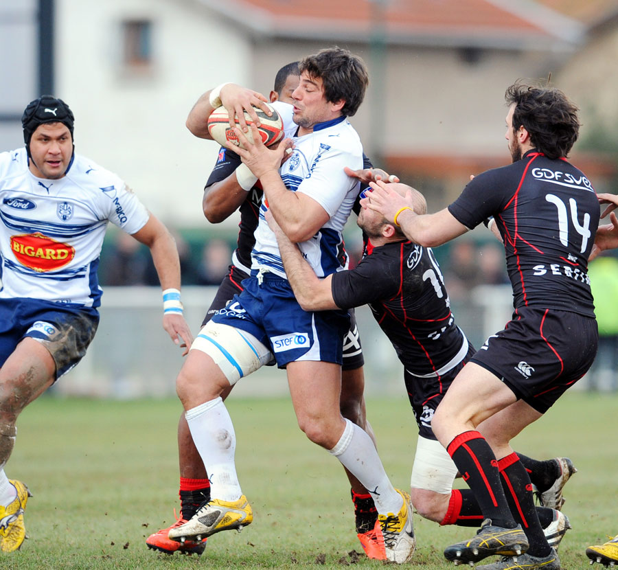 Agen centre Miguel Avramovic is wrapped up in midfield