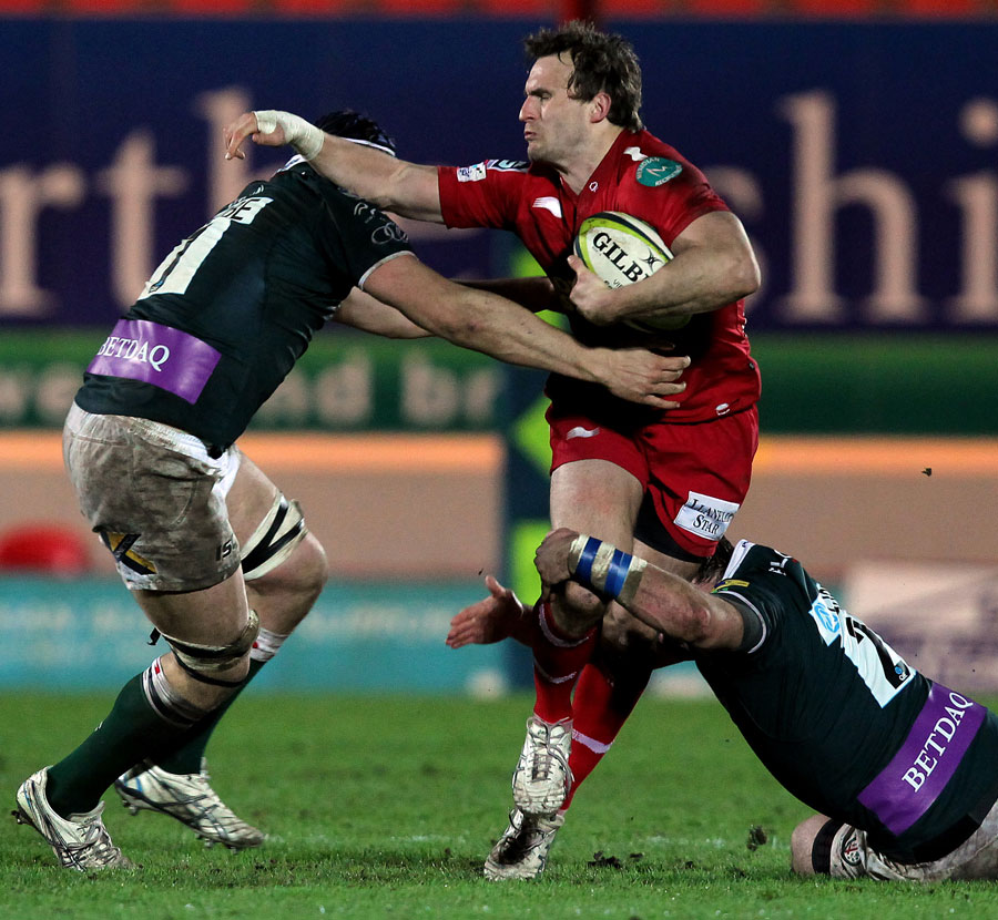 Scarlets wing Andy Fenby looks to break through the Irish defence
