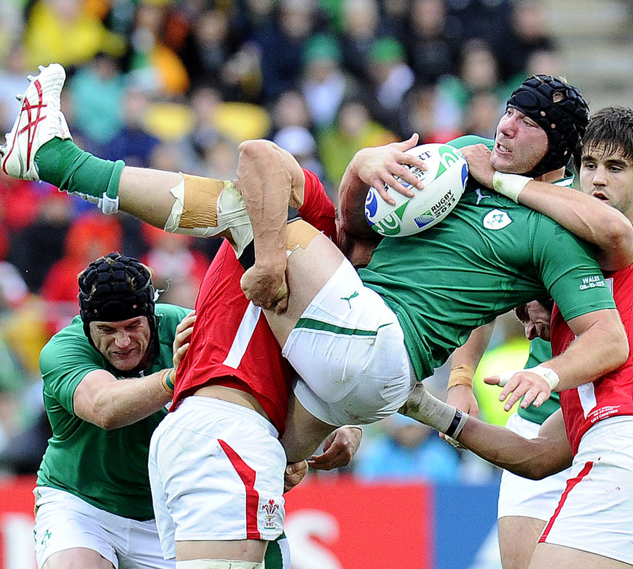 Ireland's Stephen Ferris is tackles by the Wales defence