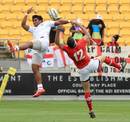 Tonga's Jack Ram challenges Owen Williams of Wales for a high ball