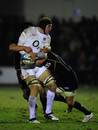 England Saxons lock Kearnan Myall is wrapped up by two Scottish tacklers