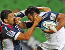 The Blues' Isaia Toeava goes head to head with the Rebels' Mark Gerrard