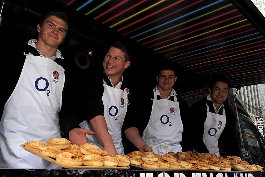 Four England stars hand out pies to the public
