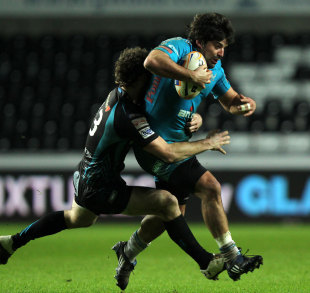 Aironi's Gabriel Pizarro tackled by Ospreys' Andrew Bishop 