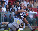 Stormers captain Schalk Burger feels the force of the Hurricanes defence