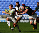 Northampton's Paul Diggin is snagged by the London Irish defence