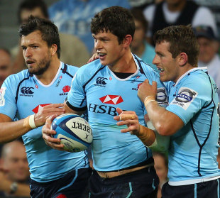 The Waratahs' Tom Carter is congratulated on a try