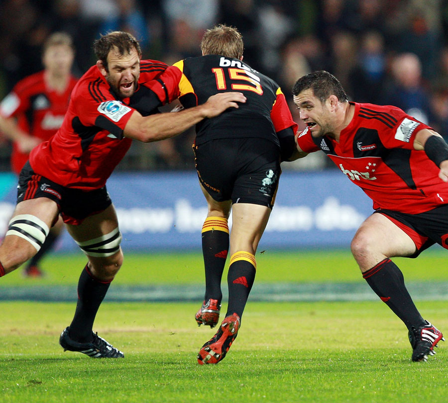 The Crusaders' George Whitelock (L) and Corey Flynn tackle the Chiefs' Robbie Robinson