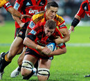 The Crusaders' Luke Romano is tackled by the Chiefs' Sonny Bill Williams