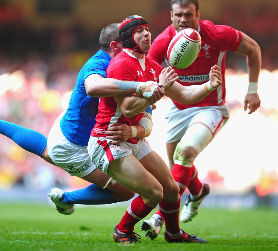 Italy's Sergio Parisse tackles Wales' Leigh Halfpenny