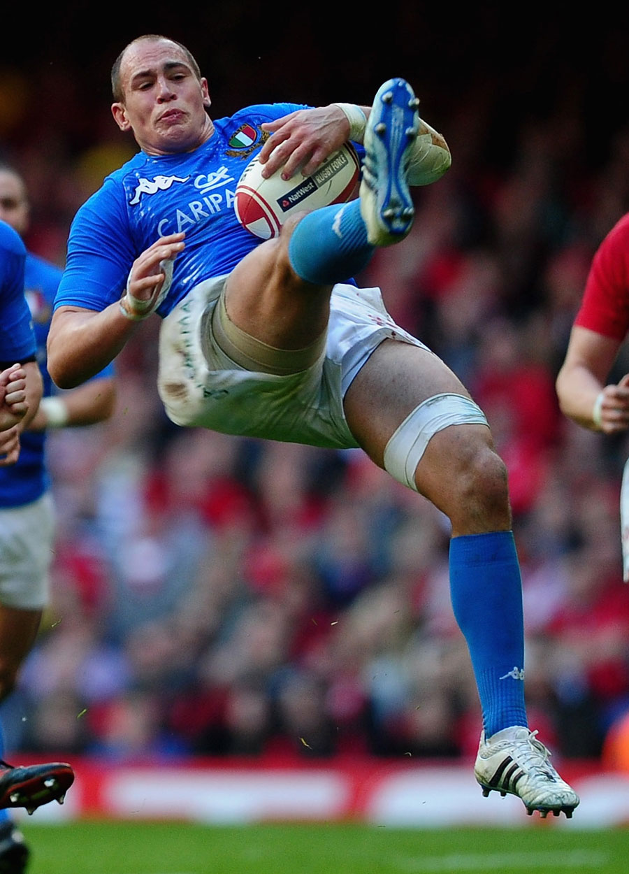Italy's Sergio Parisse comes clattering to the ground
