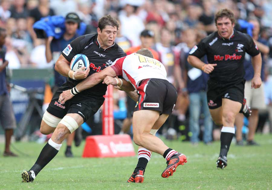 The Sharks' Willem Alberts fends off a tackle