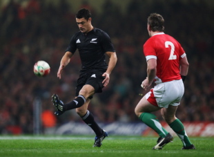 Dan Carter of the All Blacks kicks the ball past Matthew Rees during the Invesco Perpetual rugby match between Wales and the New Zealand All Blacks at Millennium Stadium on November 22, 2008 in Cardiff, Wales.
