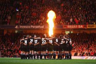 The All Blacks huddle on the pitch as pyrotechnics light the crowd prior to the start of the Invesco Perpetual rugby match between Wales and the New Zealand All Blacks at the Millennium Stadium in Cardiff, United Kingdom on November 22, 2008. 