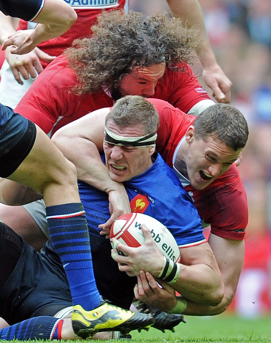 Wales' Ian Evans tackles France's Imanol Harinordoquy